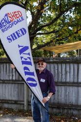 Thumbnail Image of Richard puts out the open sign for the MeNZ Shed