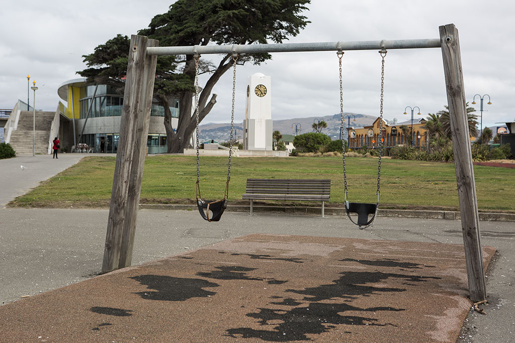 Image of Swings at the whale pool playground, looking south to the library and clock tower. Marine Parade, New Brighton. Thursday, 17 March 2016