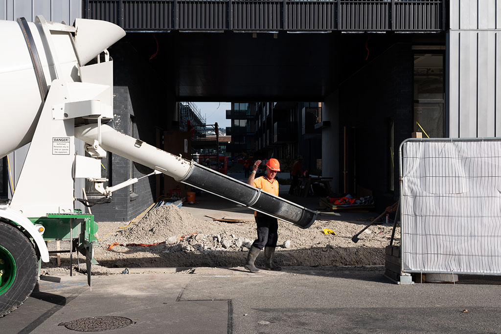 Image of Construction worker backs cement truck, Welles Street. Thursday, 19 April 2018