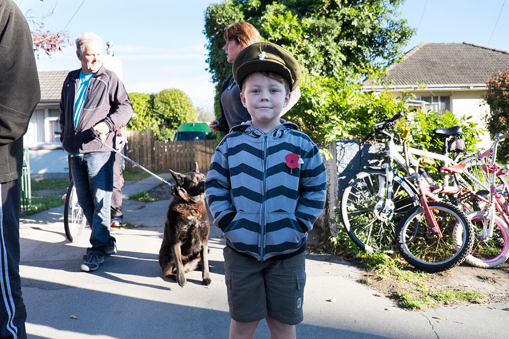 Image of Boy proudly wears the hat from his grandfather's war uniform while watching the Anzac Day service 2015, 320 Halswell Road. 25-04-2015 9.11 a.m.