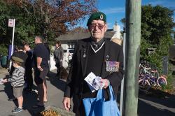 Thumbnail Image of Man hands out Anzac Ribbons to children at the Anzac Day parade