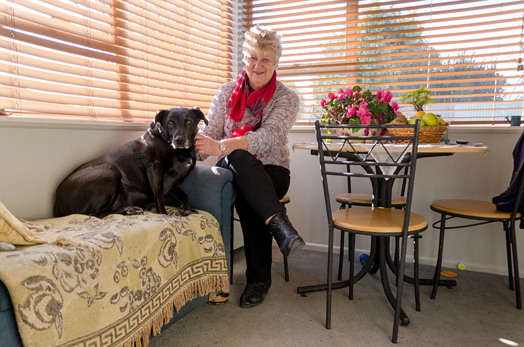 Image of Jill with her black Labrador in her dining room. 12-08-2015 3:41 p.m.