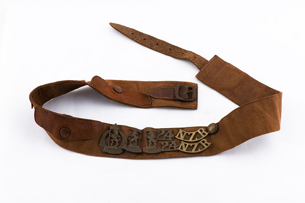 Image of Leather money belt with added badges and button. ca. 1917