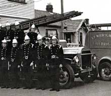 The only known photo of the library built in 1911 was this one taken in 1945 with the fire brigade in the foreground Caption