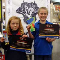 Maya and Kristina recieve their prizes at Bishopdale Library