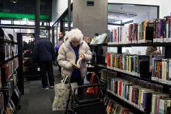 Thumbnail Image of Looking through books, opening, Ōrauwhata : Bishopdale Library