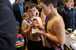 Thumbnail Image of Young boys who performed in the Kapa haka group tuck in