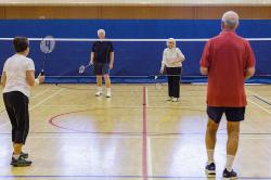 Thumbnail Image of Members of the social Badminton Club in the middle of a rally