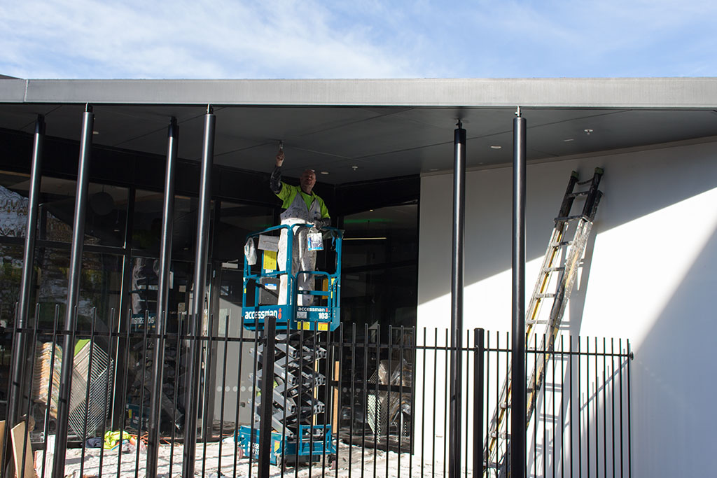 Image of Worker painting the new library Tuesday, 11 July 2017