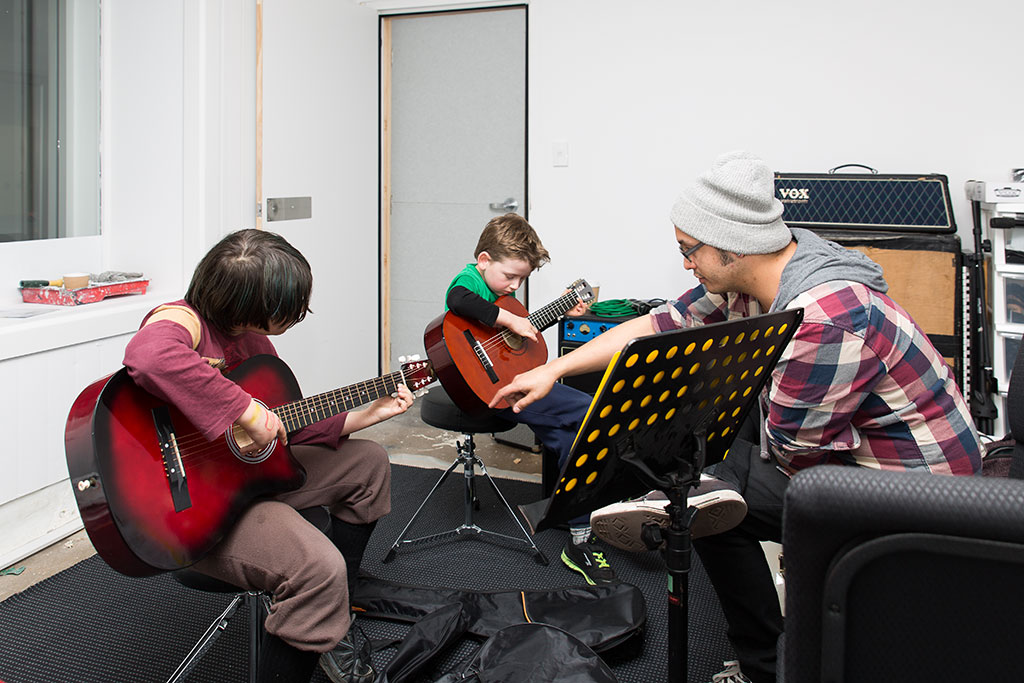 Image of Children learning to play guitar at the Grace Vineyard Beach Campus. Youth Alive Trust Classes. 17-08-2016 4:52 p.m.