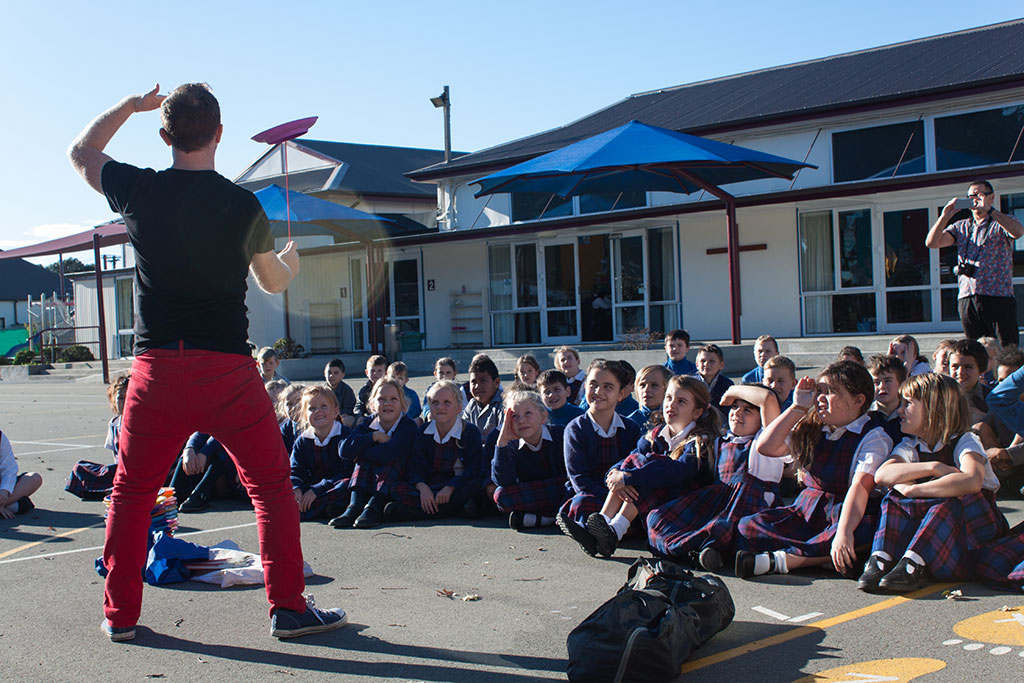 Image of A circus performer demonstrates how to spin plates, New Brighton Catholic School, Lonsdale Street. Friday, 13 May 2016