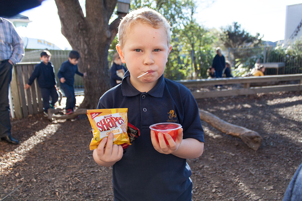 Image of A student shows off his morning tea, South New Brighton School. Thursday, 28 July 2016