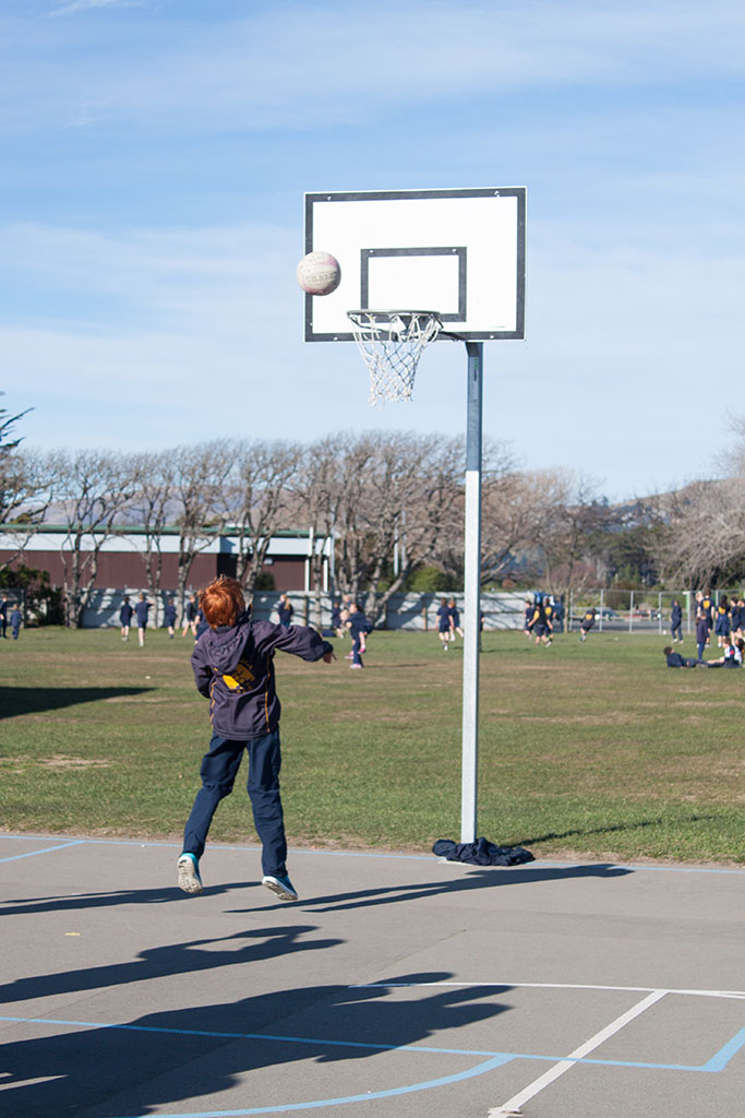 Image of A student plays with a basketball, South New Brighton School. Thursday, 28 July 2016