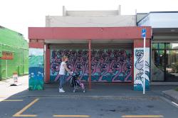 Thumbnail Image of A shopper passes a decorated bus stand, New Brighton Mall
