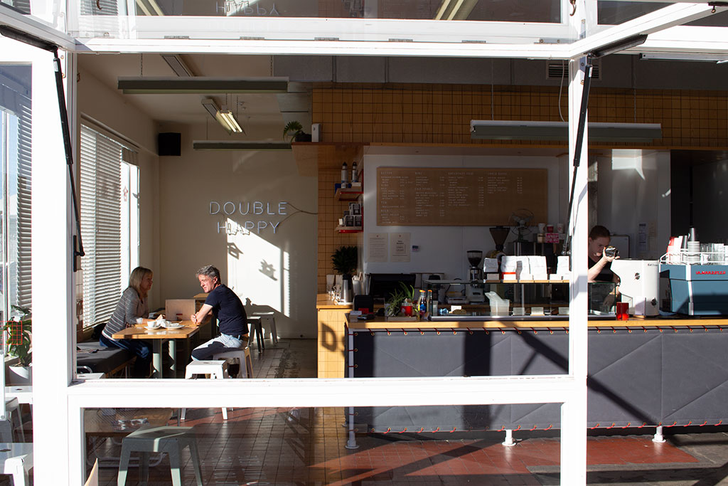Image of A couple share the afternoon sun together in Supreme cafe, 7 Welles Street. Sunday, 22 April 2018