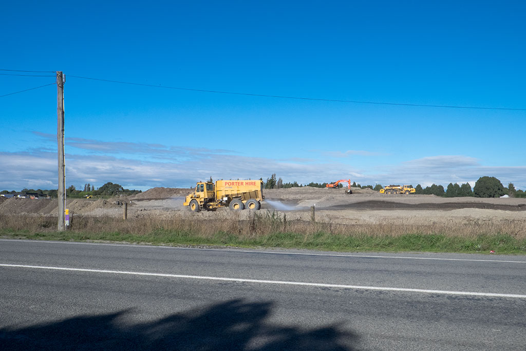 Image of Trucks working on the road for the beginnings of a new subdivision being built on Halswell Junction Road. 30-03-2015 10.57 a.m.