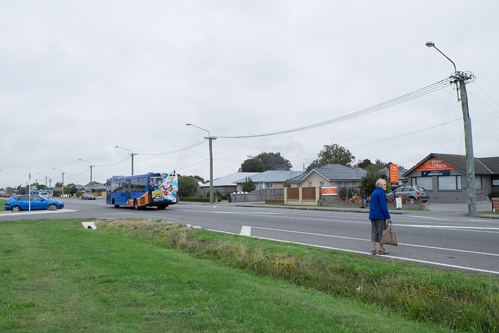 Image of Woman disembarks bus, crosses Halswell Road. 27-03-15 10.52 a.m.