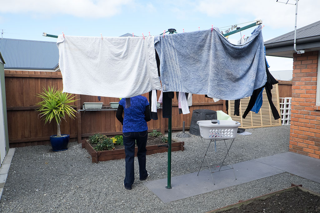 Image of Karen hangs out washing in a section of her back garden at Grace Close, Aidanfield subdivision. 23-04-2015 12.42 p.m.