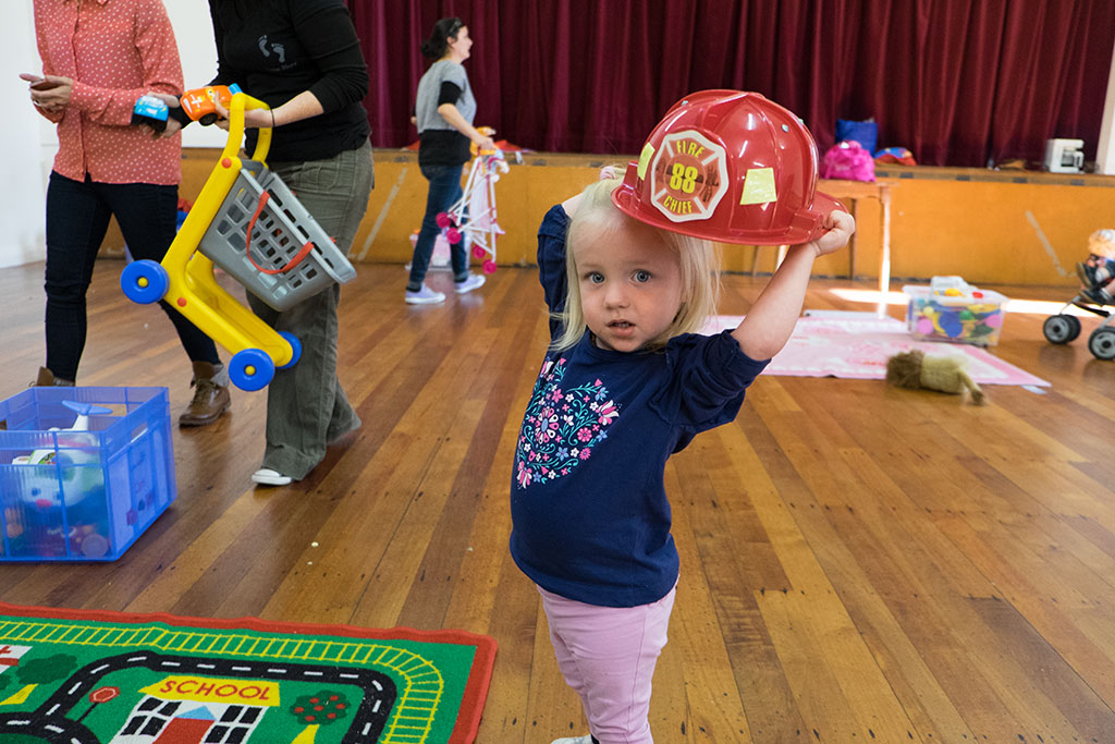 Image of Girl plays with fireman's hat at Little Steps community group, Halswell Community Hall, 450 Halswell Road. 24-04-15 11.11 a.m.