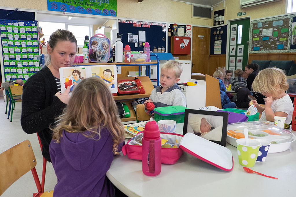 Image of Mel (student teacher) reads to Austin, Abby and another child at Kidsfirst Kindergarten on Wales Street. 18-05-15 10.53 a.m.