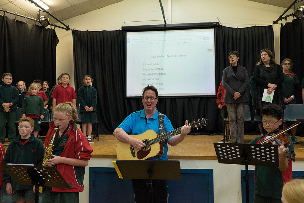 Image of Geoffrey McCallum, music teacher at Oaklands Primary School, performs with students at the school assembly. 25-05-15 2.12 p.m.