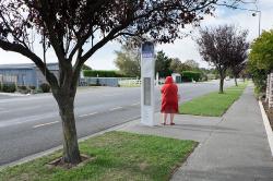 Thumbnail Image of Woman waits at bus stop