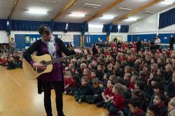 Thumbnail Image of Stacey, an Oaklands Primary School teacher, tunes her guitar