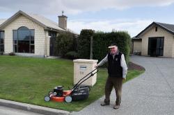 Thumbnail Image of Roger mowing his front lawn