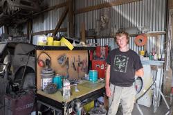 Thumbnail Image of Shaun in the work shop of his father's panel beating business