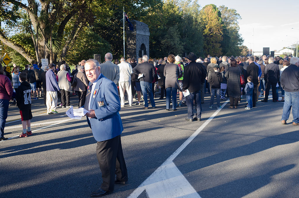 Image of Veteran hands out programs at ANZAC Day centenary parade, Halswell Road. 25-04-2015 9;55 a.m.