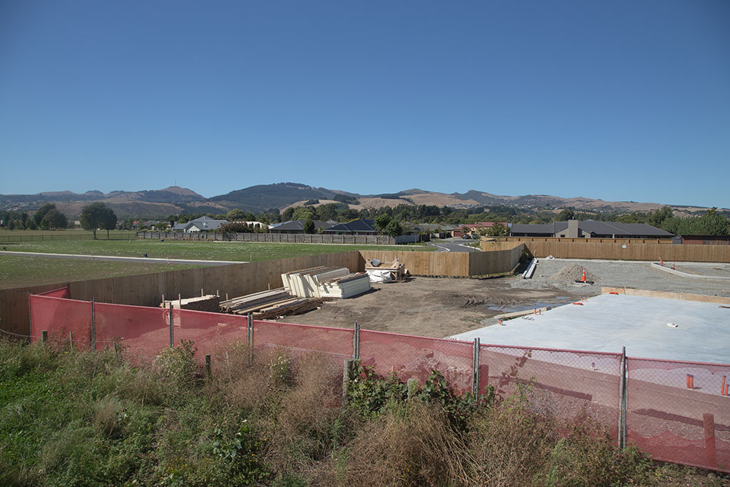 Image of Elements of the Halswell Library under construction in front of a subdivision. 9/03/2015 12:34