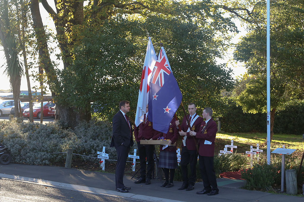 Image of Cashmere High School students in uniform, with flags, ANZAC Day memorial service. 25/04/2015 8:39